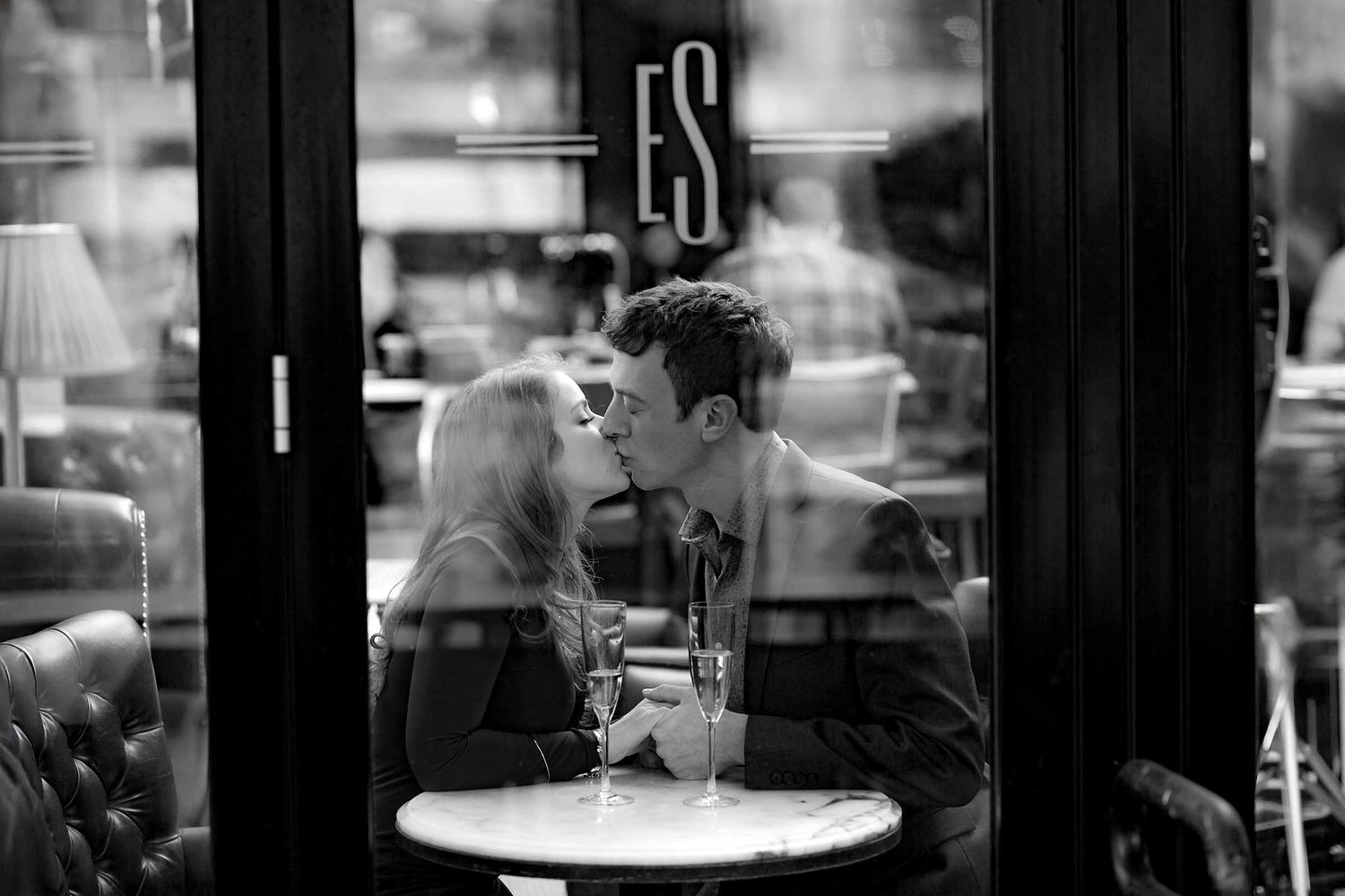 The couple share a passionate kiss while dining at the Eastern Standard Restaurant during their Boston Engagement Shoot.