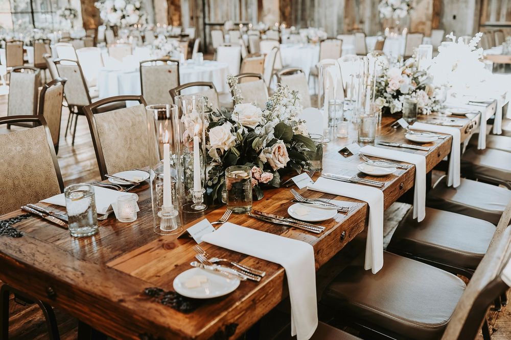 Soft candlelight glowing on rustic wooden tables at Hotel Drover reception