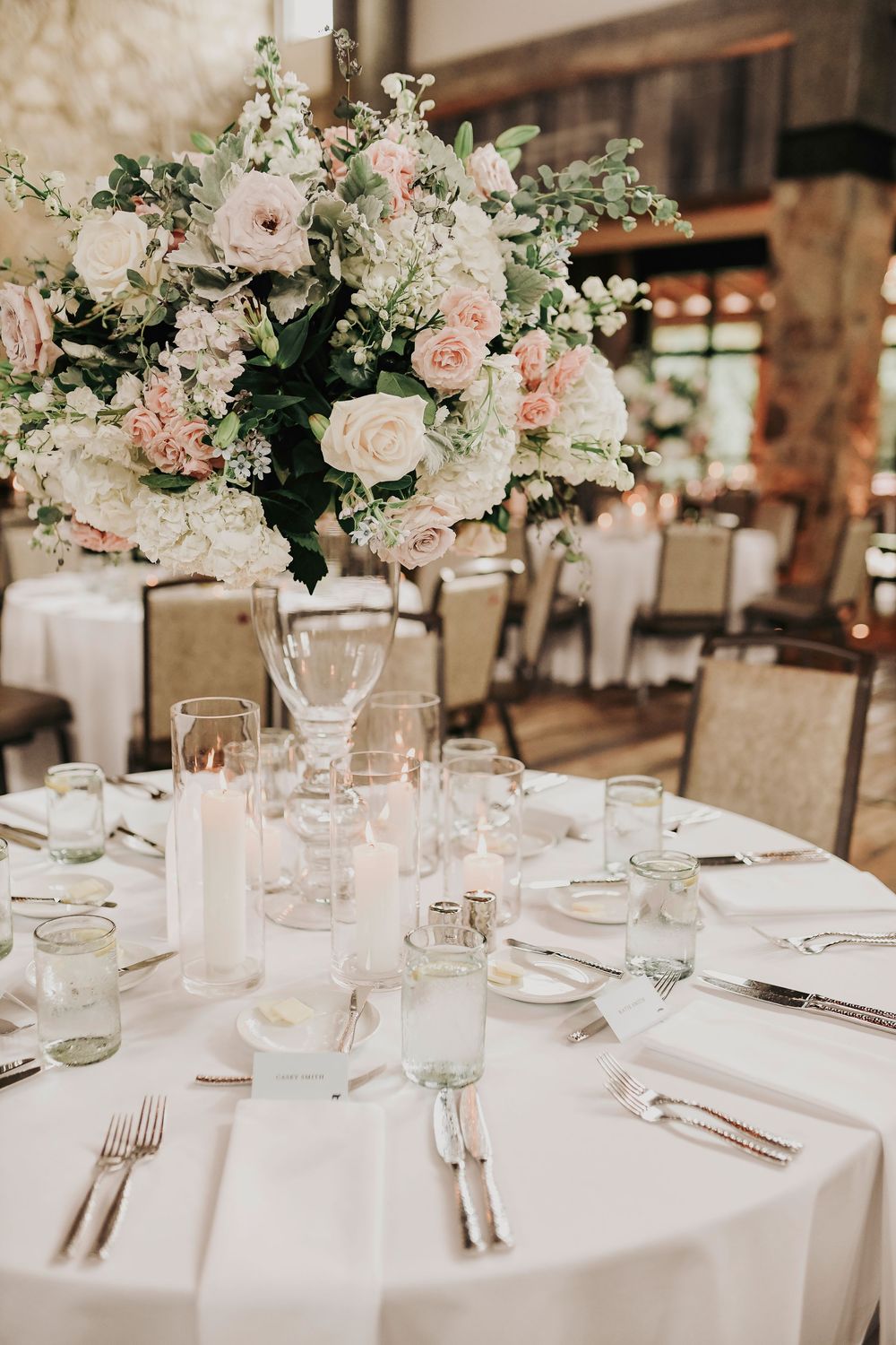 Overhead view of round tables with powder blue napkins and gold flatware