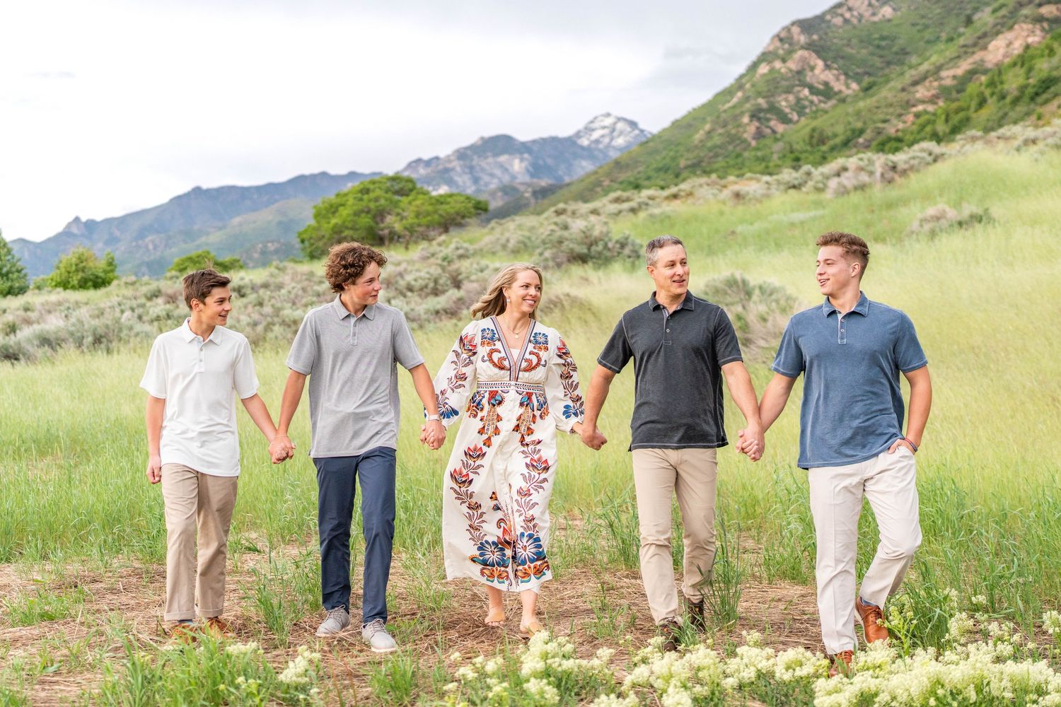 True to color photo of family holding hands in Wasatch park.