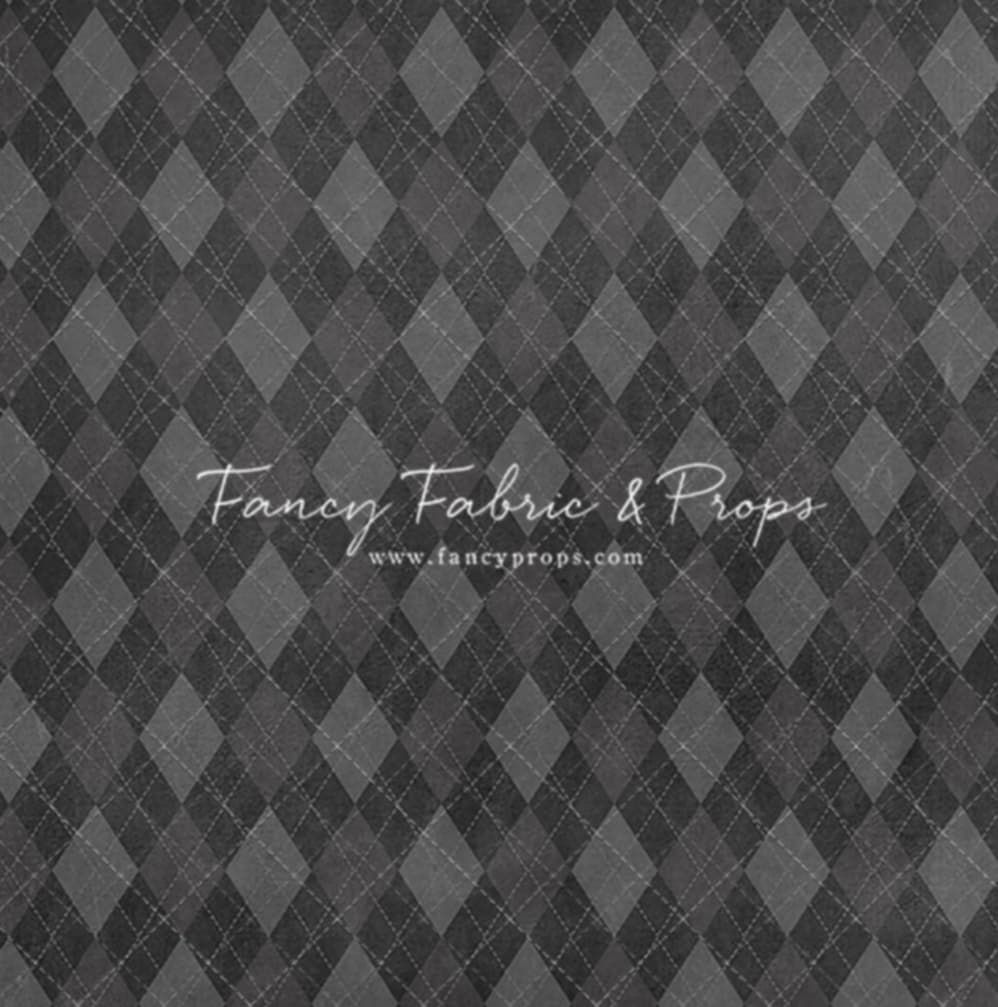A grey diamond pattern background with elegant white script text reading "Fancy Fabric & Props".