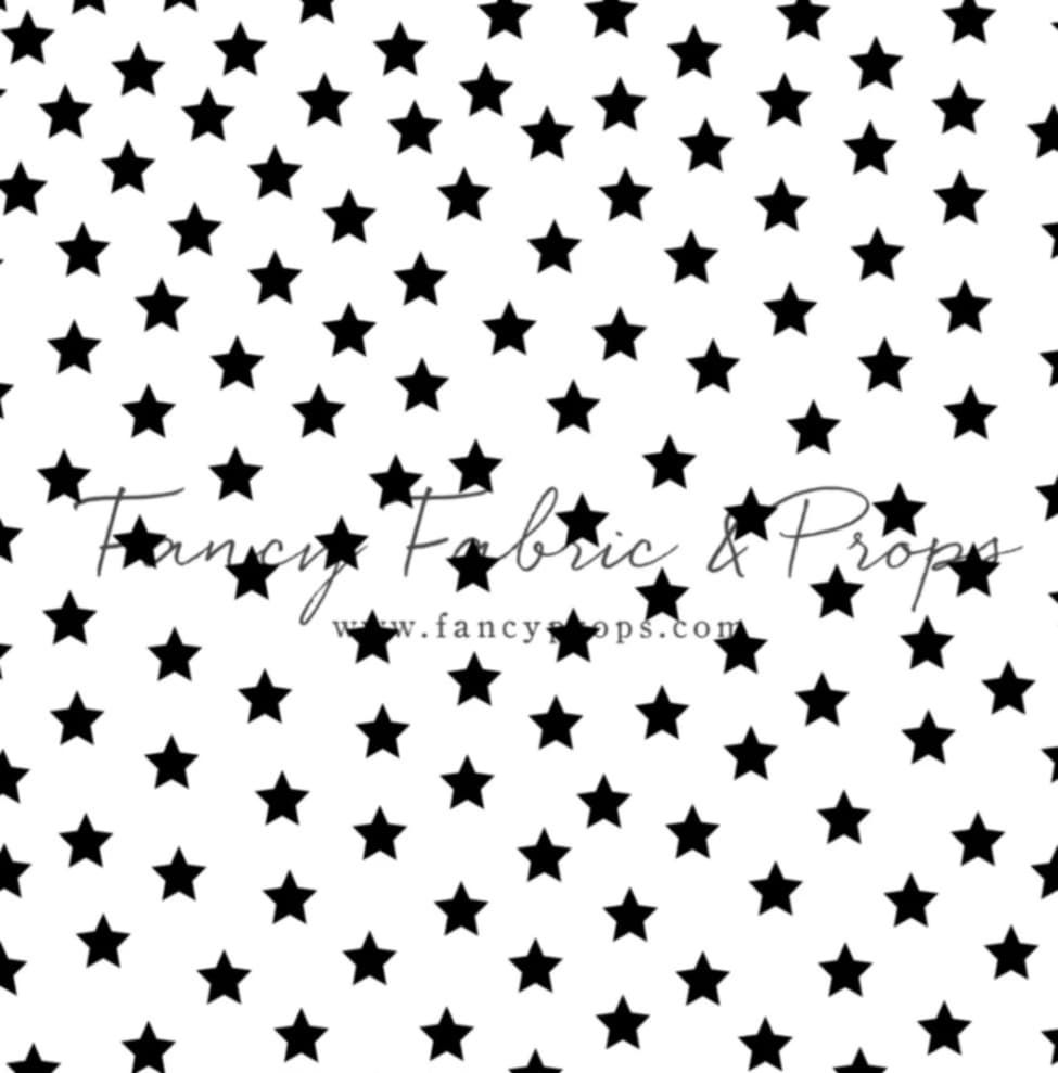 Seamless pattern featuring randomly scattered black stars on a white background creating a celestial texture.