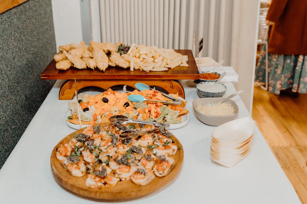 Appetizer spread featuring various canapés and finger foods on wooden serving platters.