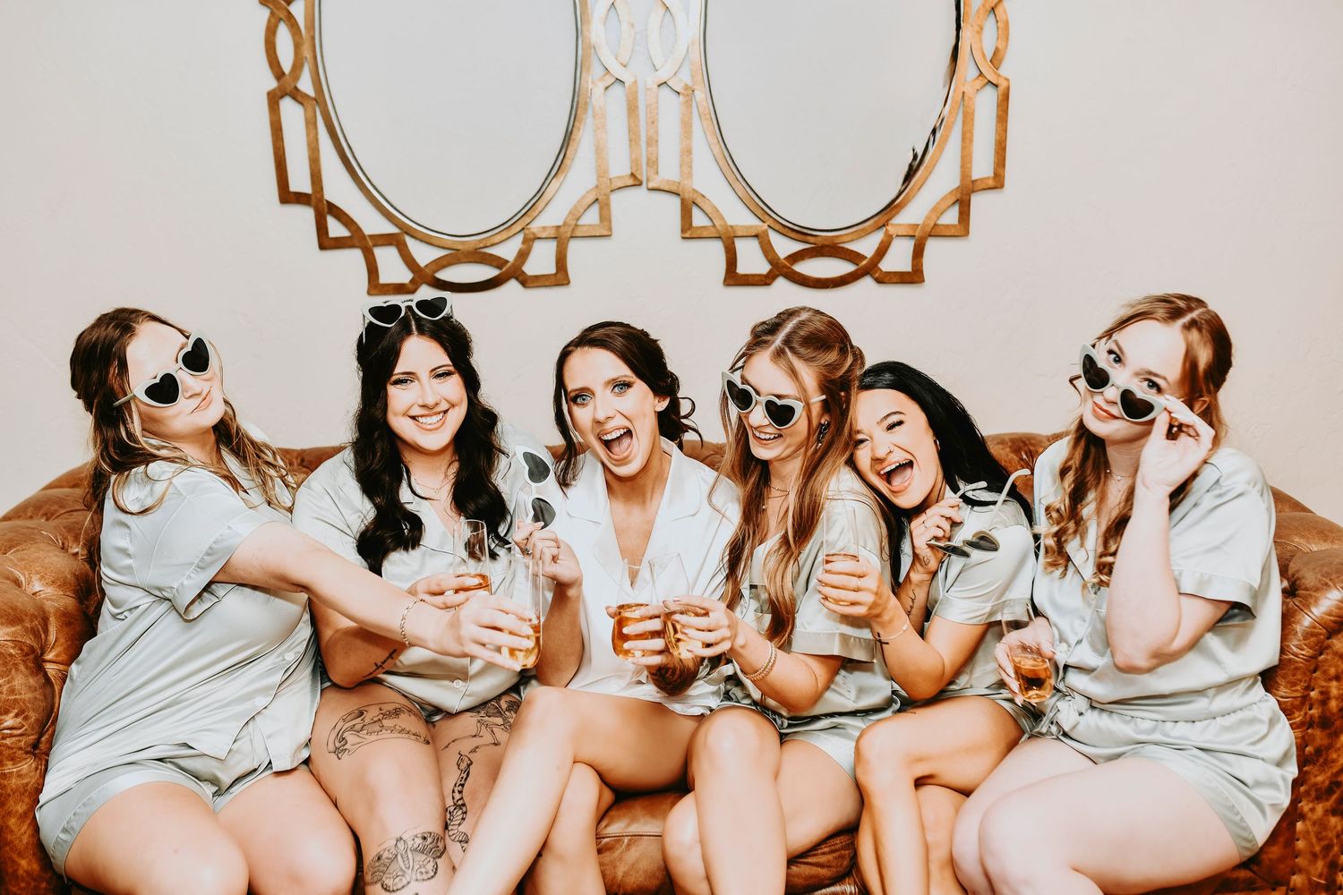 fun bridal party and bride having pre-ceremony fun with champagne and sunglasses in the bridal suite at the lodge at the springs