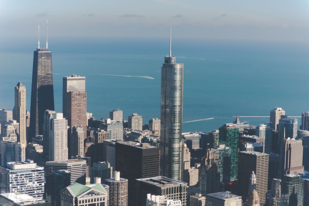 Aerial view of Chicago's iconic skyline featuring the John Hancock Center and Trump Tower along Lake Michigan.