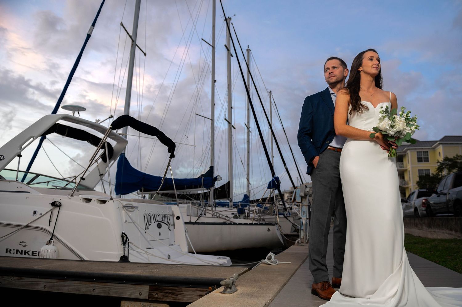 Couple dancing on the dock at golden hour, perfectly timed by their Jupiter wedding photographer.