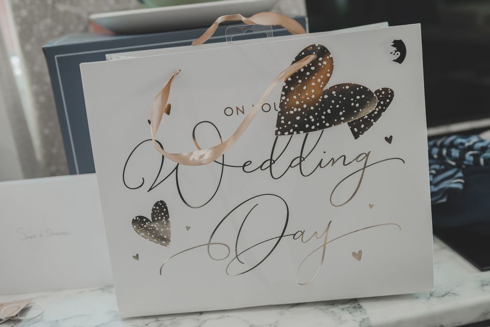 Elegant wedding day card with gold glitter butterfly and calligraphy text.