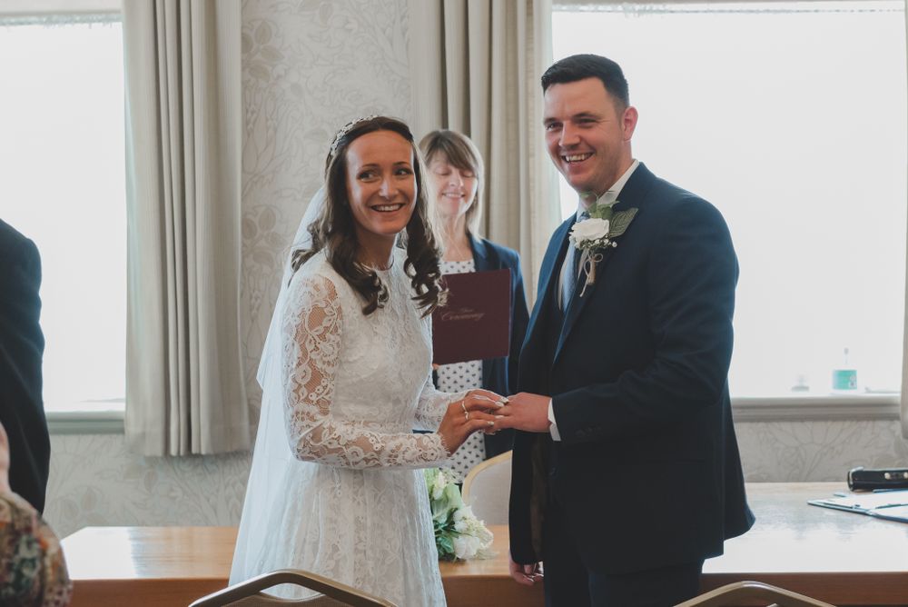 Couple participates in ring exchange ceremony during their wedding service.