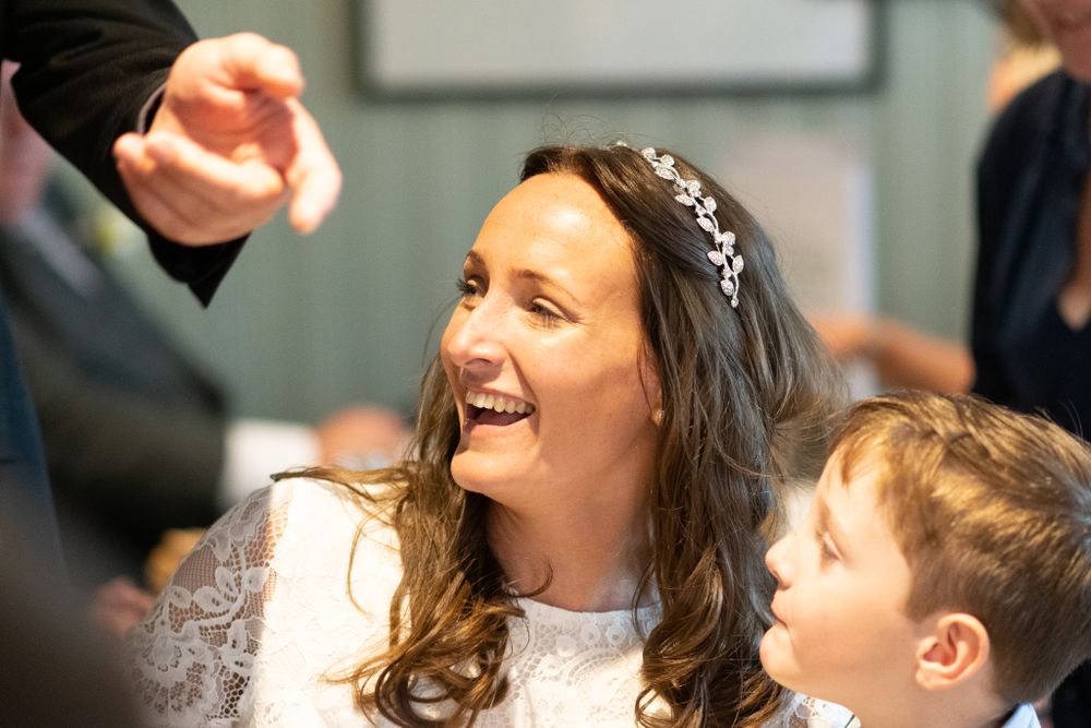 A wedding celebration scene capturing joyful laughter during the reception.