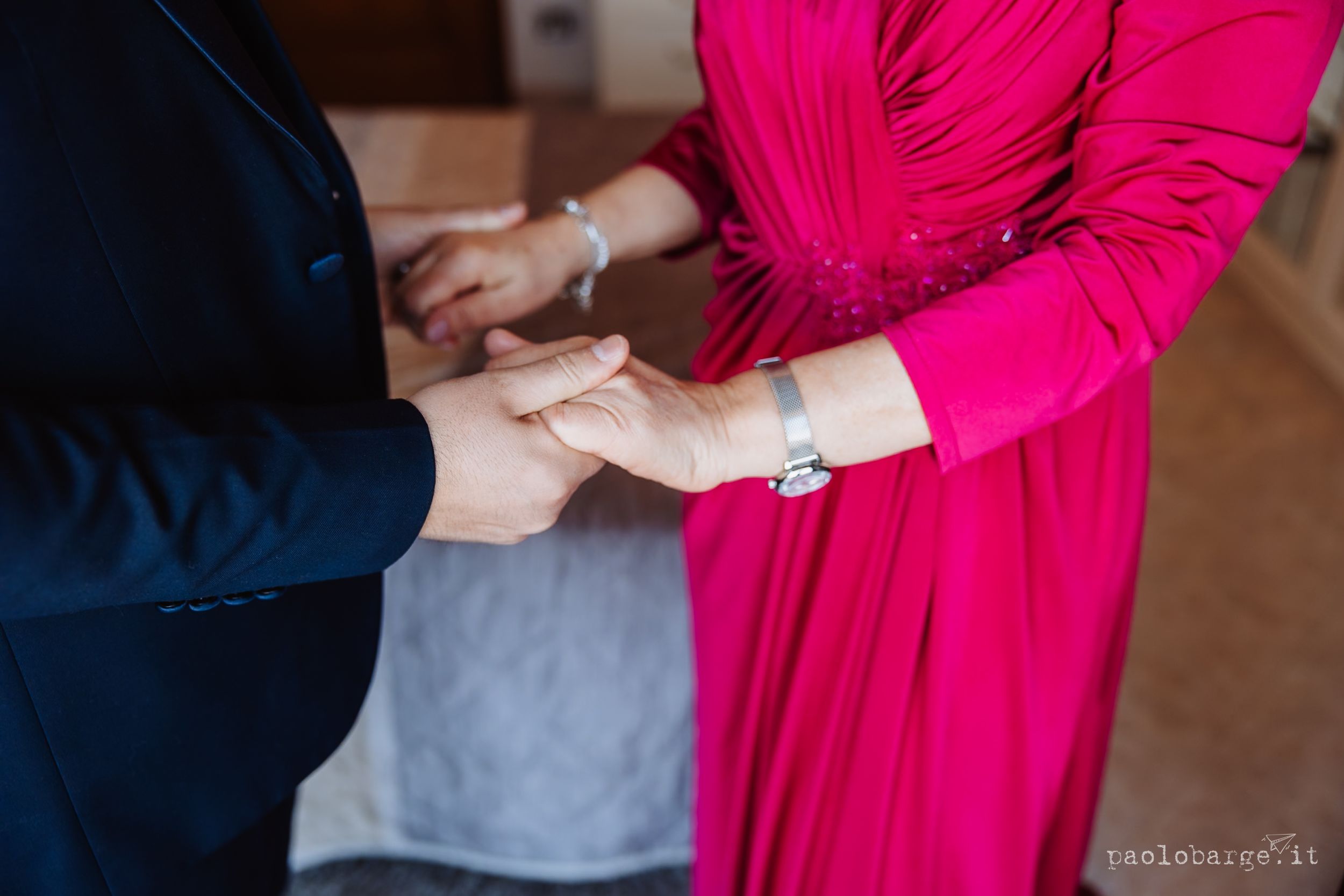 Hands hold a pink book or document showing different pages in a sequential panel layout.