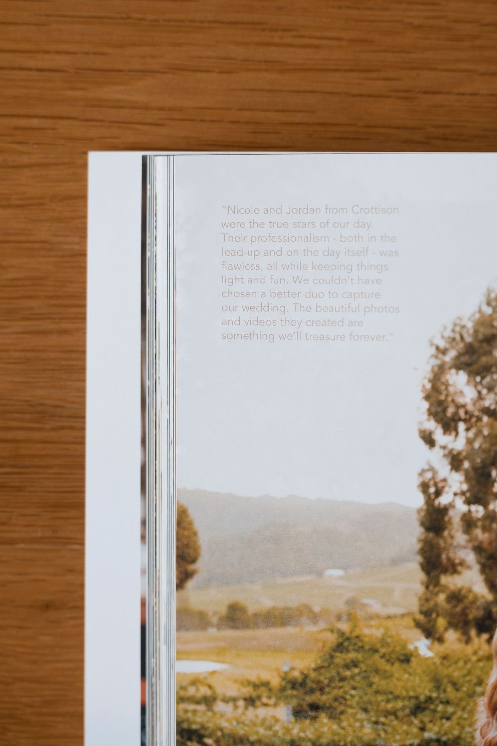 A coffee table book or photo album lies open showing landscape pages with mountains and trees in sepia tones.