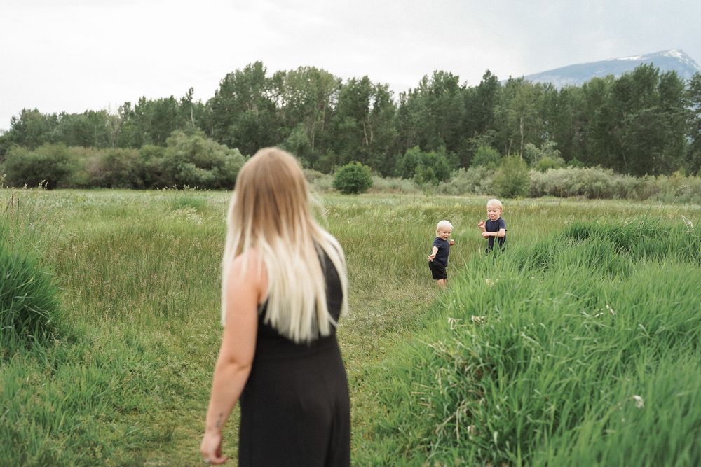 A sequence of nature path views shows a person with long blonde hair walking through tall grass and wildflowers.