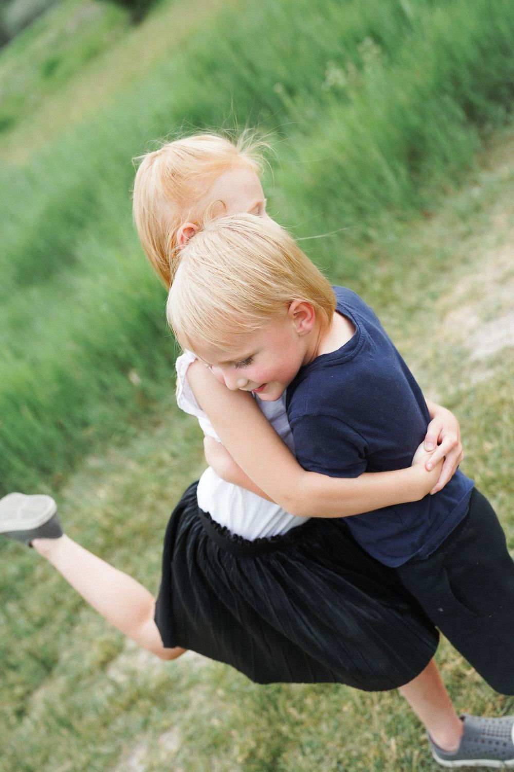 A sequence shows a child in a navy shirt and dark pants performing a cartwheel on grass in dynamic motion.