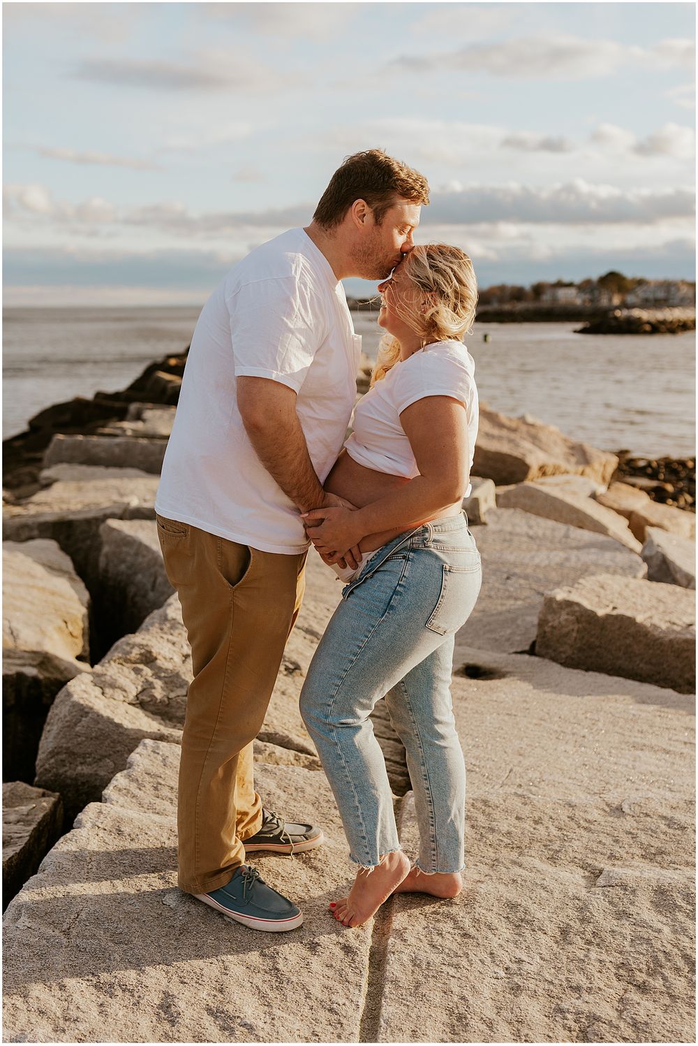NH couple taking maternity photos at the beach