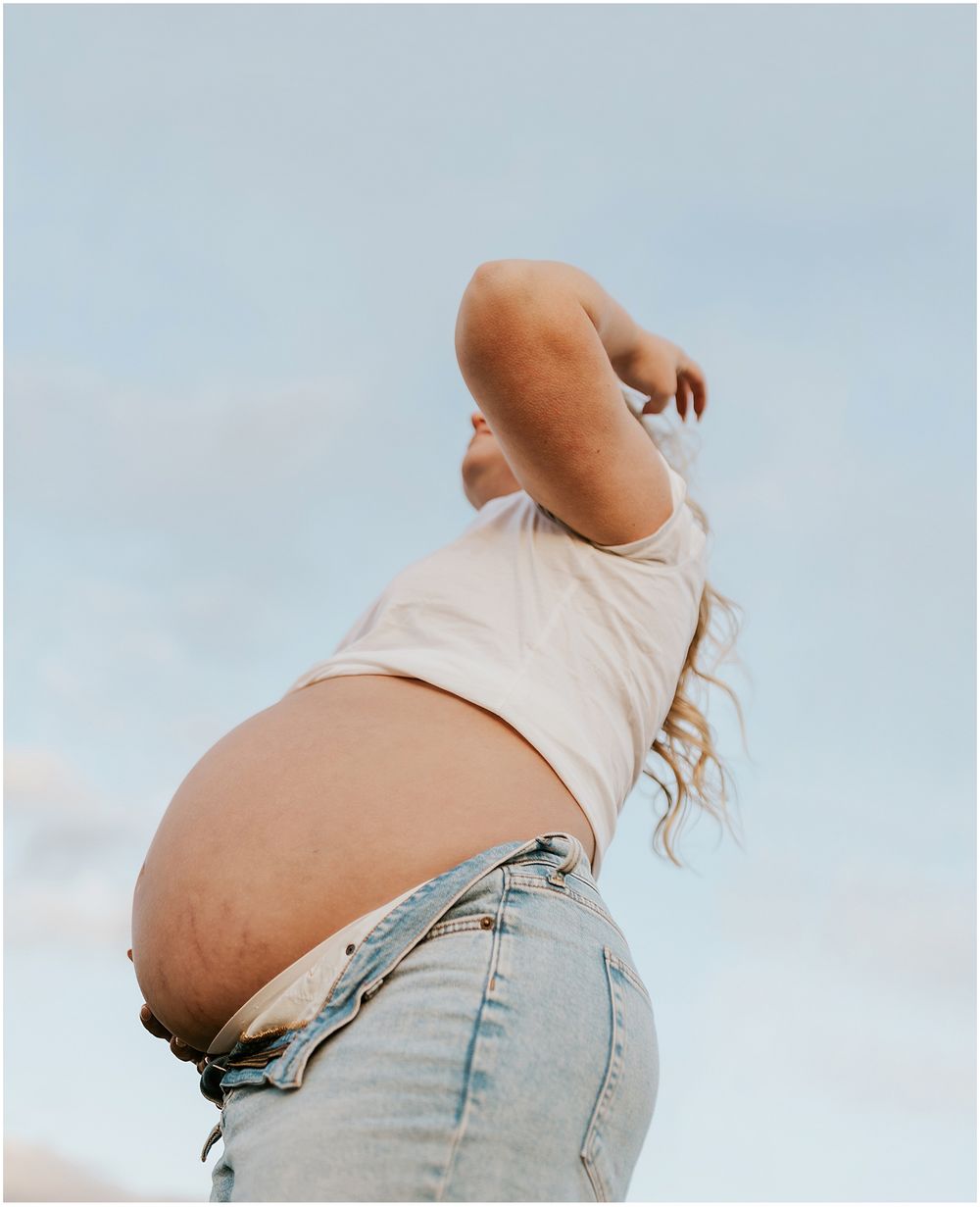 Woman taking maternity photos in NH