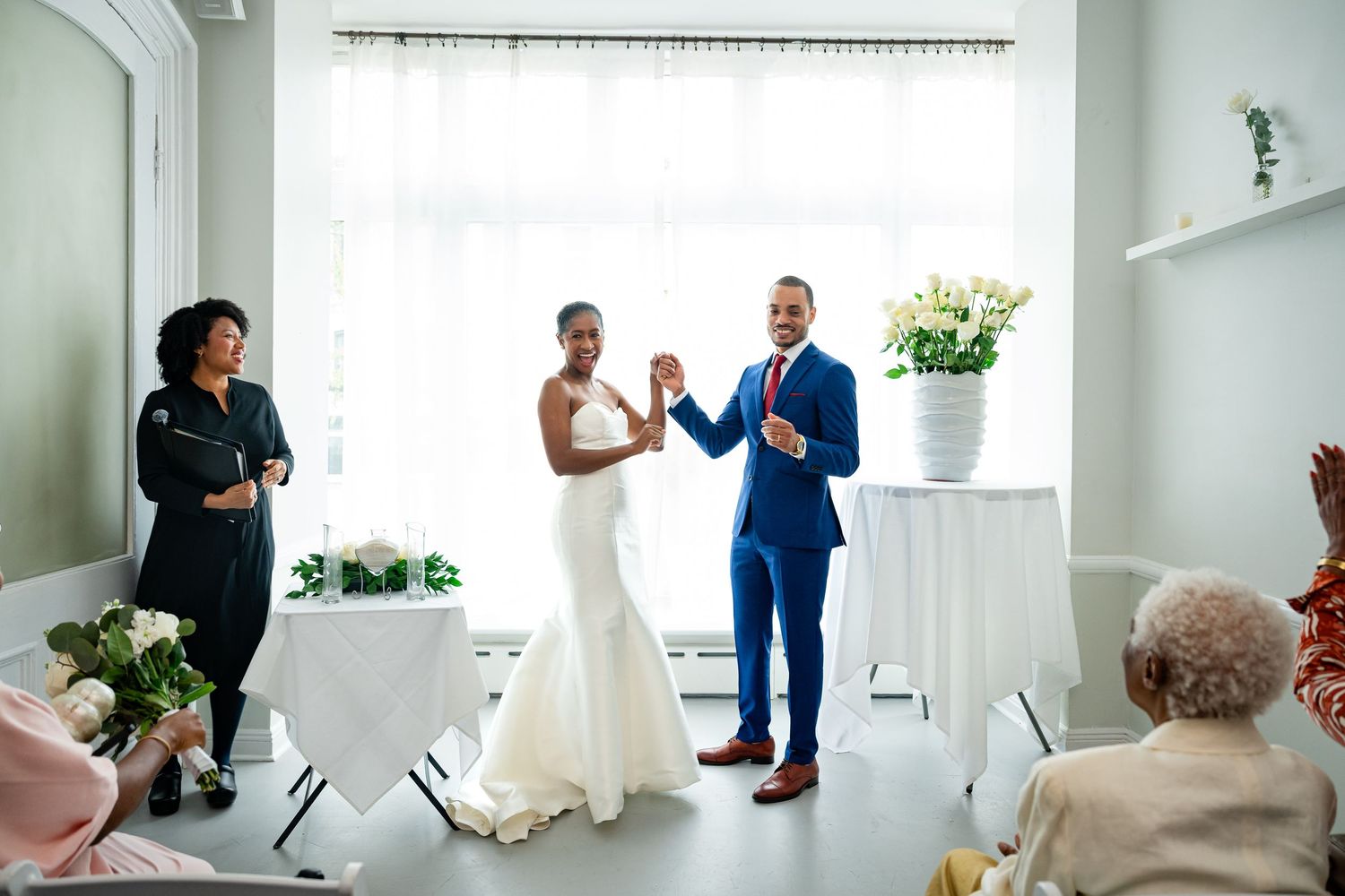 A candid wedding photography series showing intimate moments and poses in a bright white studio space.