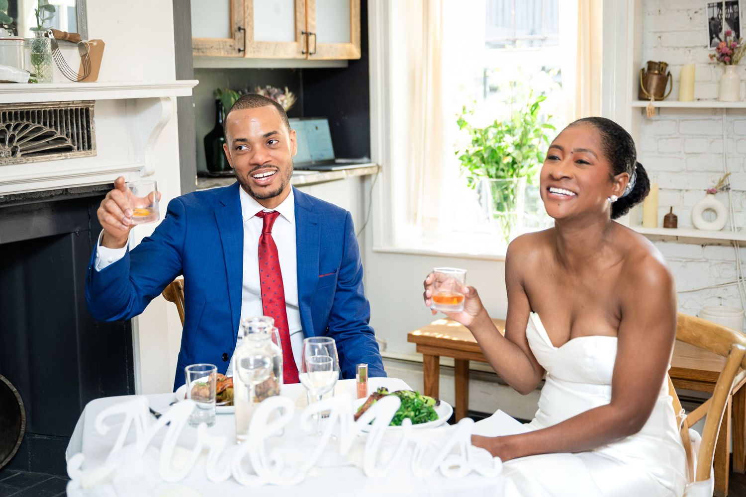 Candid wedding celebration shots showing laughter and joy around a decorated table.