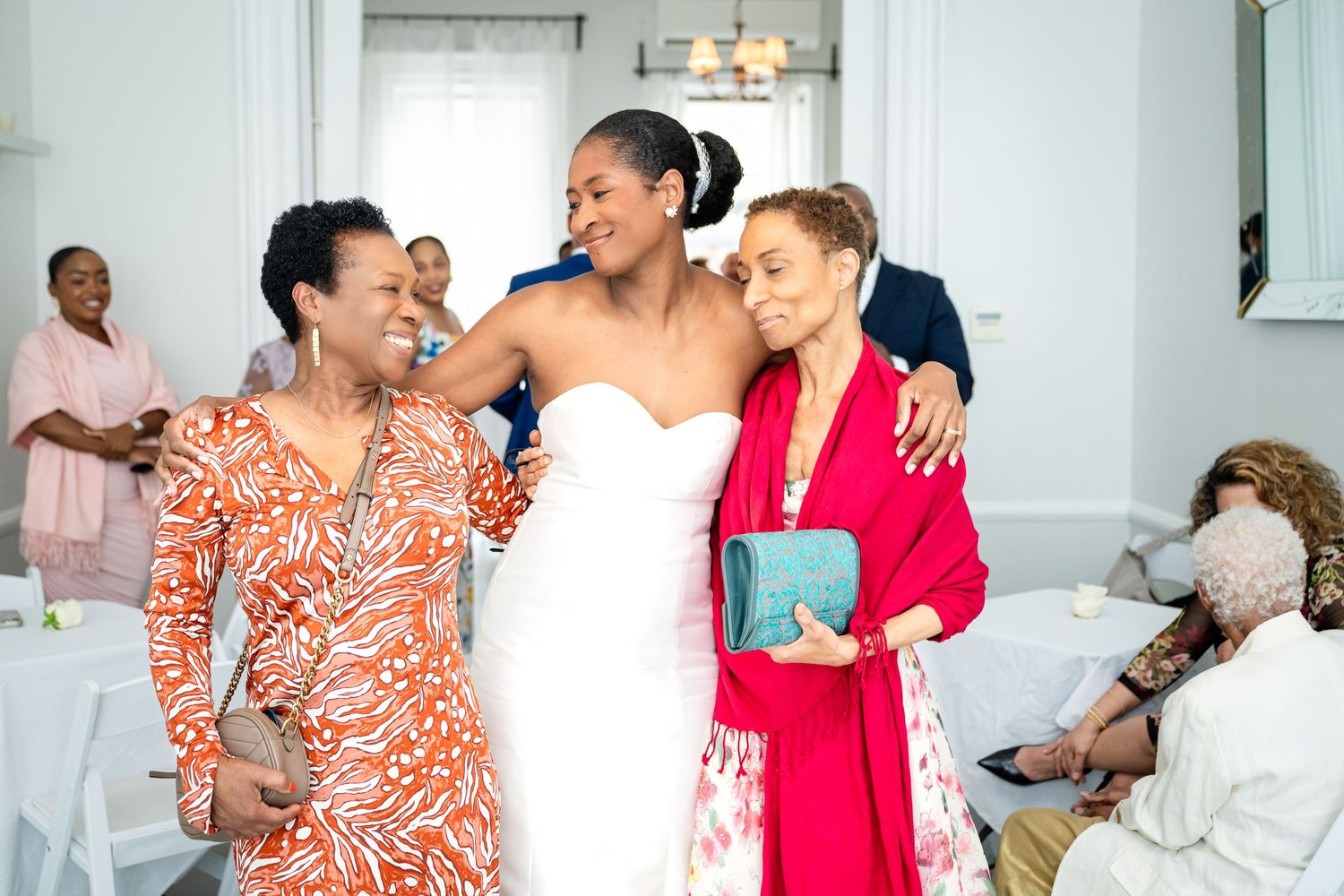 Wedding guests sharing an emotional moment with the bride during celebrations.