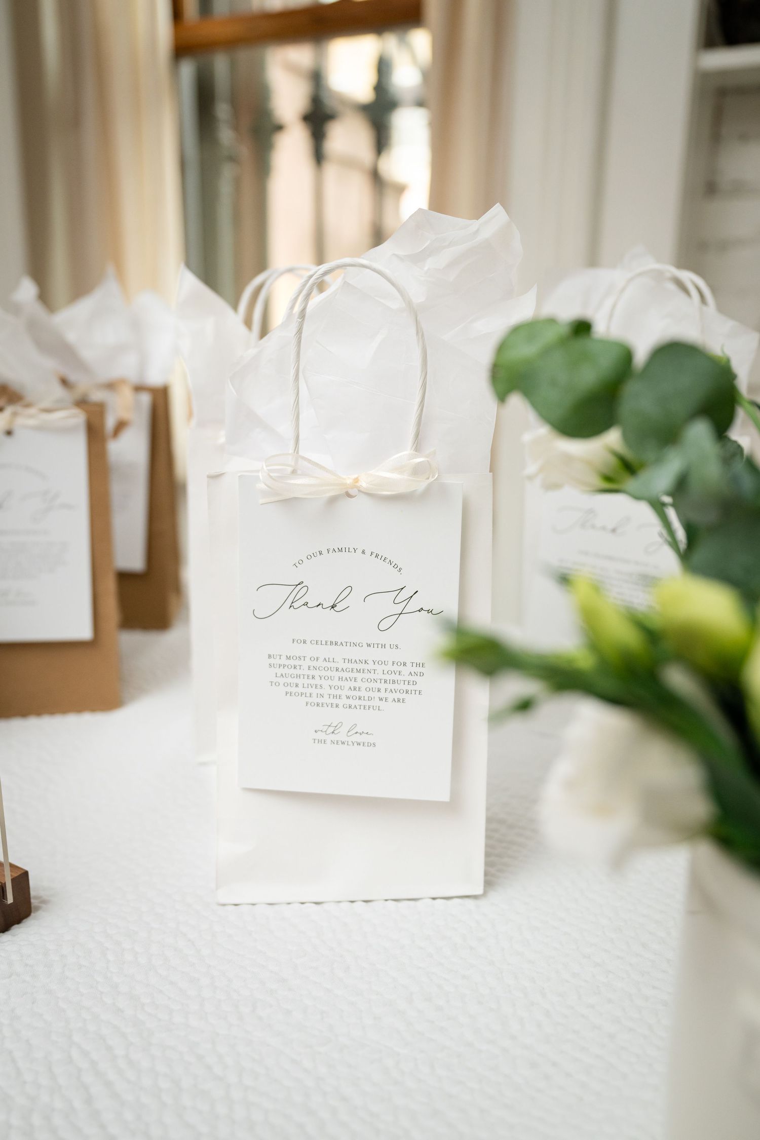 White place cards with elegant calligraphy displayed in a row at a formal event.