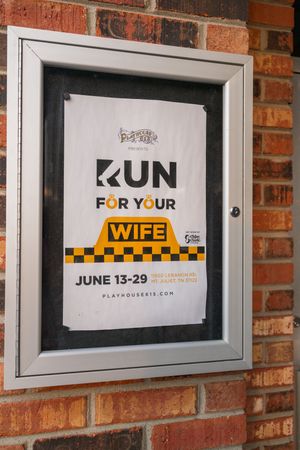 Three minimalist posters mounted on a brick wall with yellow and black text displaying the word 'RUN' and related messaging.