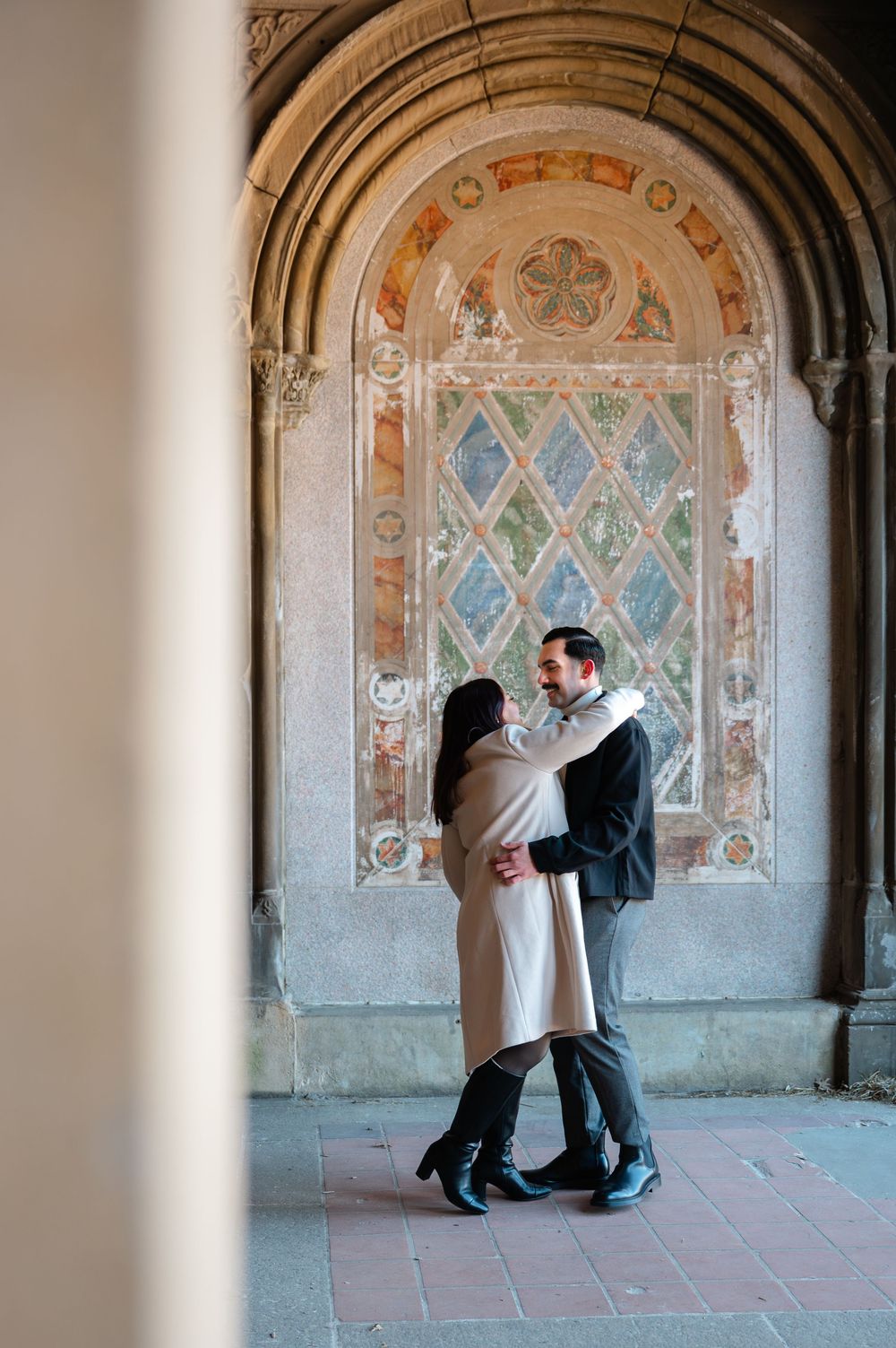 Marriage proposal silhouette in archway with romantic lighting and decorative geometric patterns.