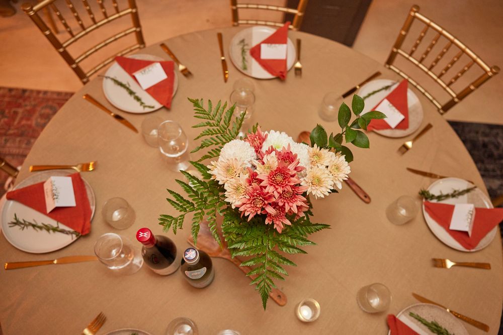 Elegant Bat Mitzvah dinner tablescape in Brooklyn. Warm florals, gold accents, & personalized details captured by George Robert Photography.
