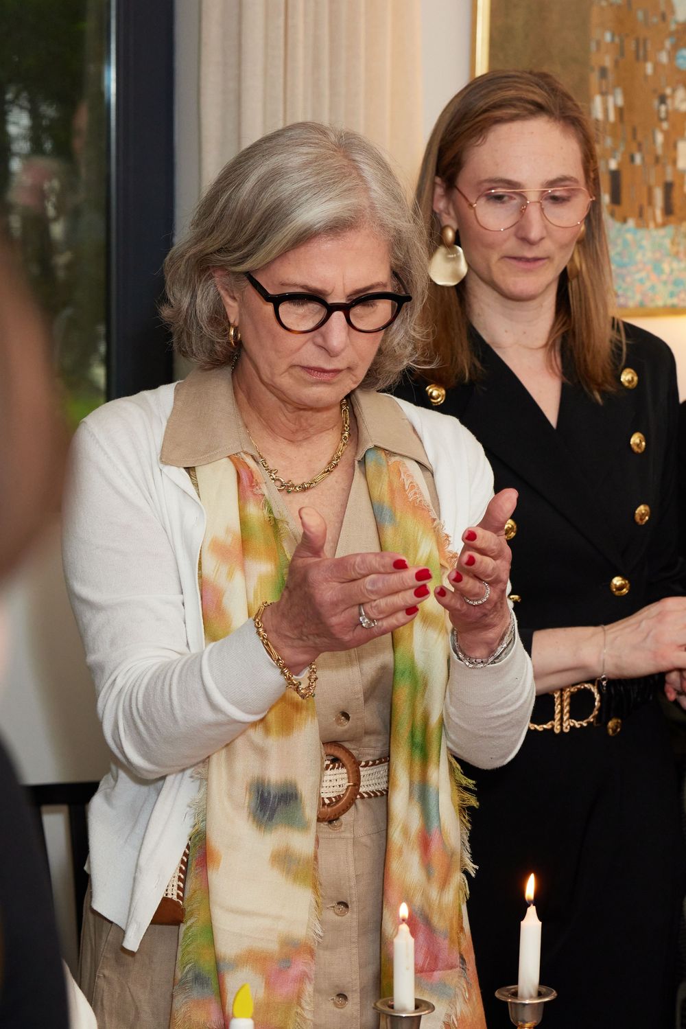Jewish grandmother lighting Shabbat candles in Brooklyn. Intimate Bat Mitzvah moment captured by George Robert Photography.