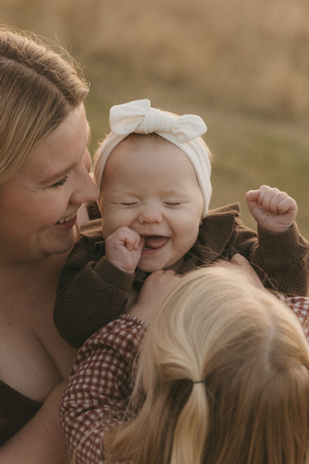 A tender, candid sequence showing playful affectionate moments in warm sepia tones.