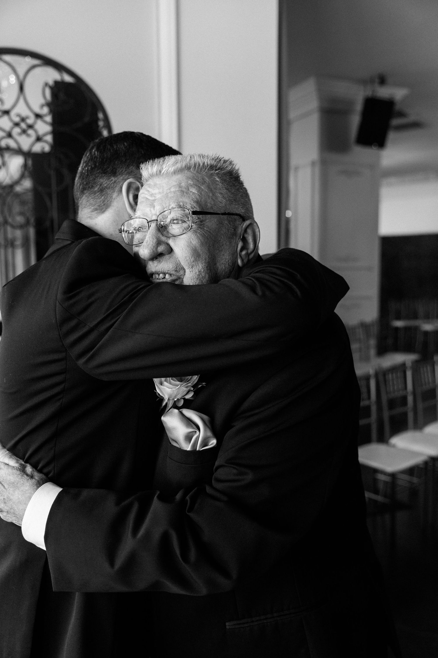 A series of black and white photos showing two elderly people in an emotional embrace.