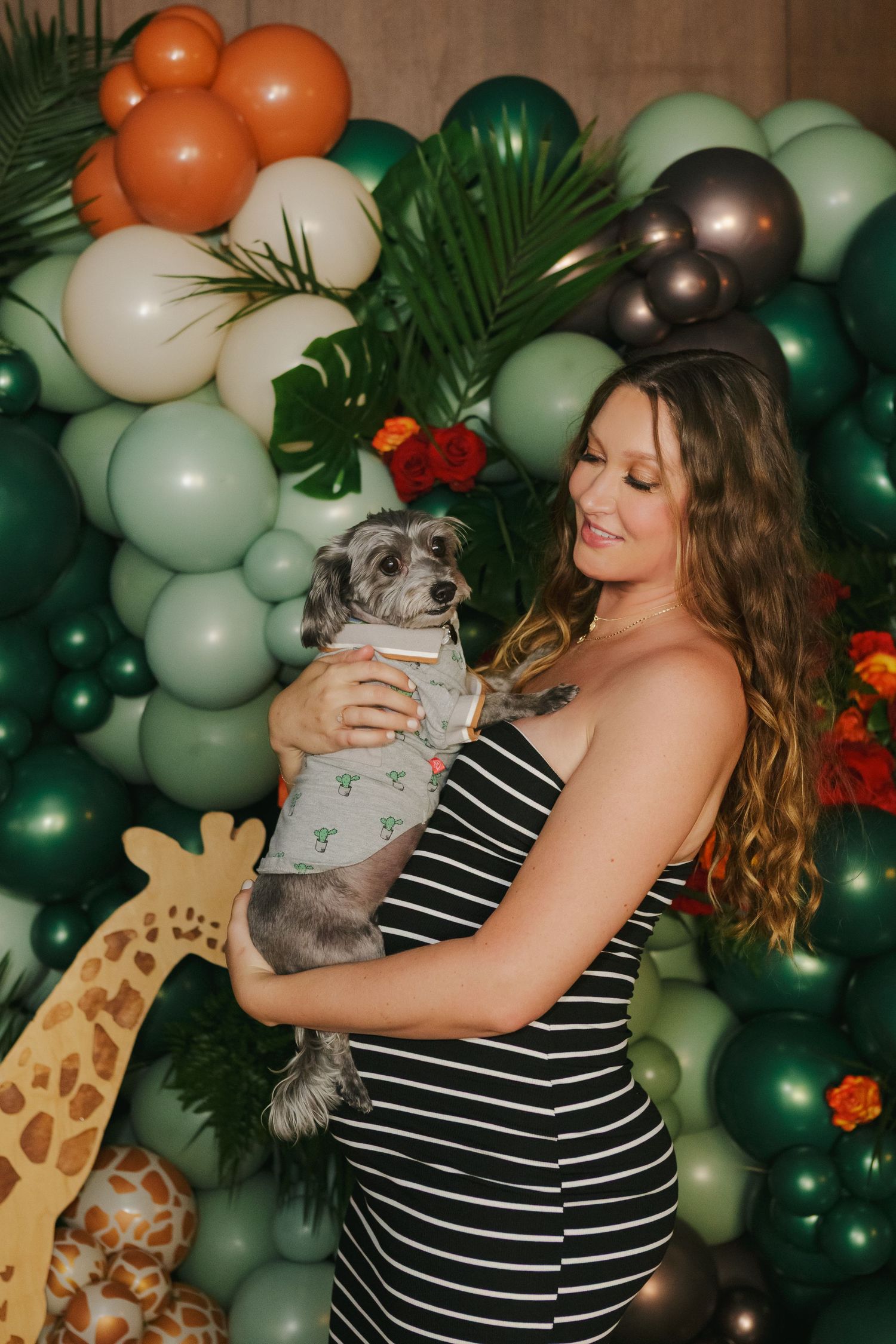 Tender moment—expecting mother snuggles with her dog during her elegant baby shower in Manhattan’s Financial District