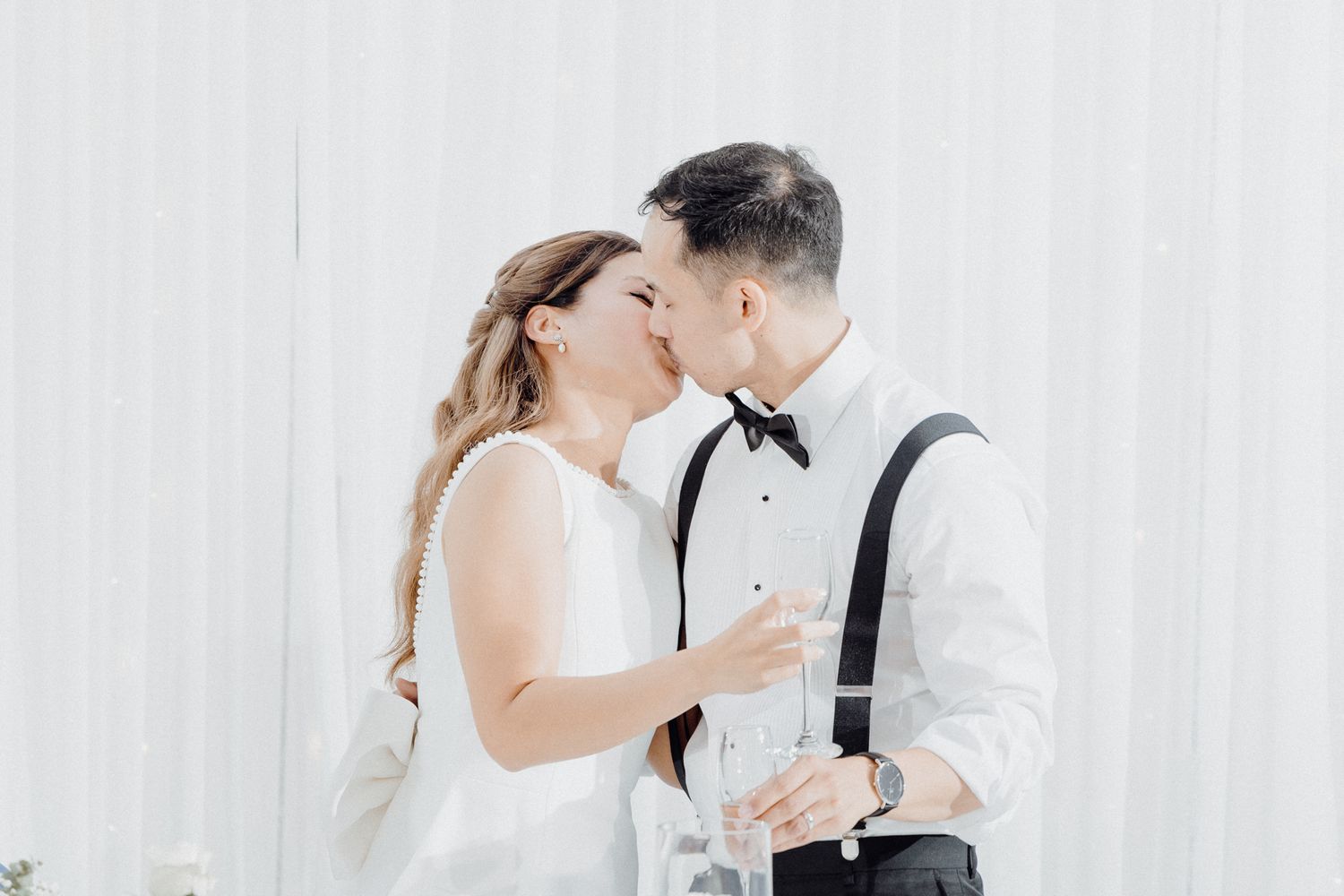 A romantic couple in wedding attire share an intimate moment captured by Apertured Media Auckland Wedding Photographer.