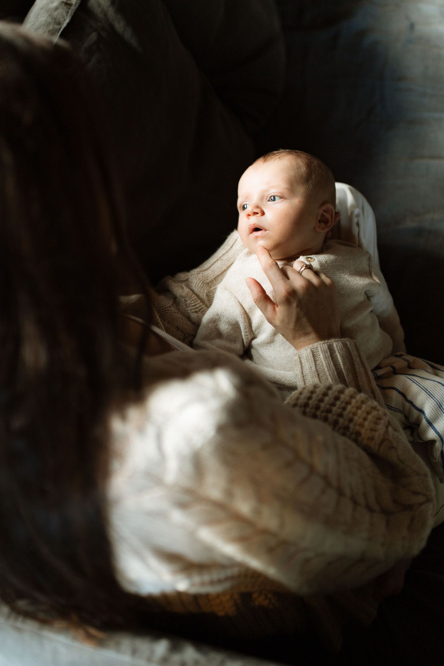 fine art photograph of newborn baby with his mother in the natural window light of their home