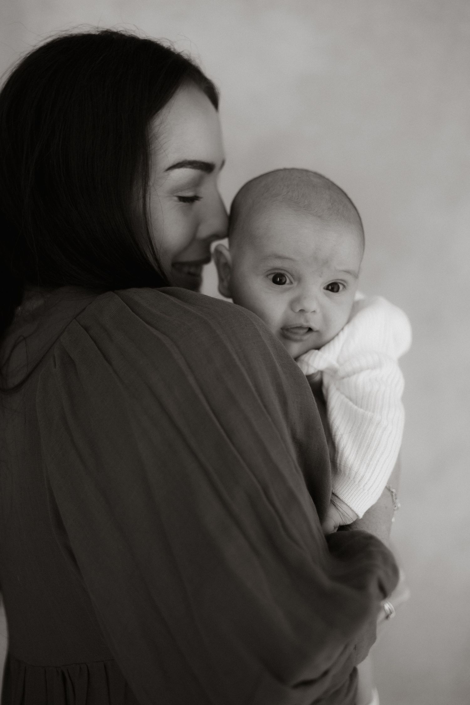 Motherhood photo with newborn baby in black and white