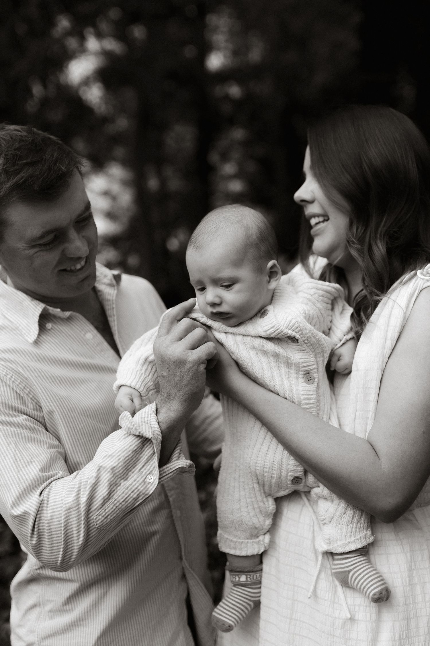 Mum, Dad and baby cuddling in black and white
