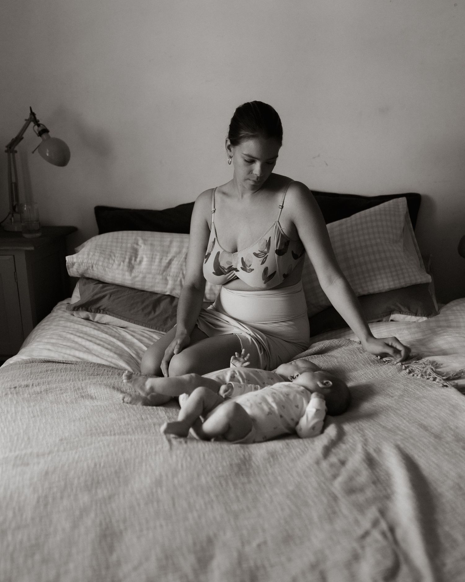 Mother and her children on their bed in black and white
