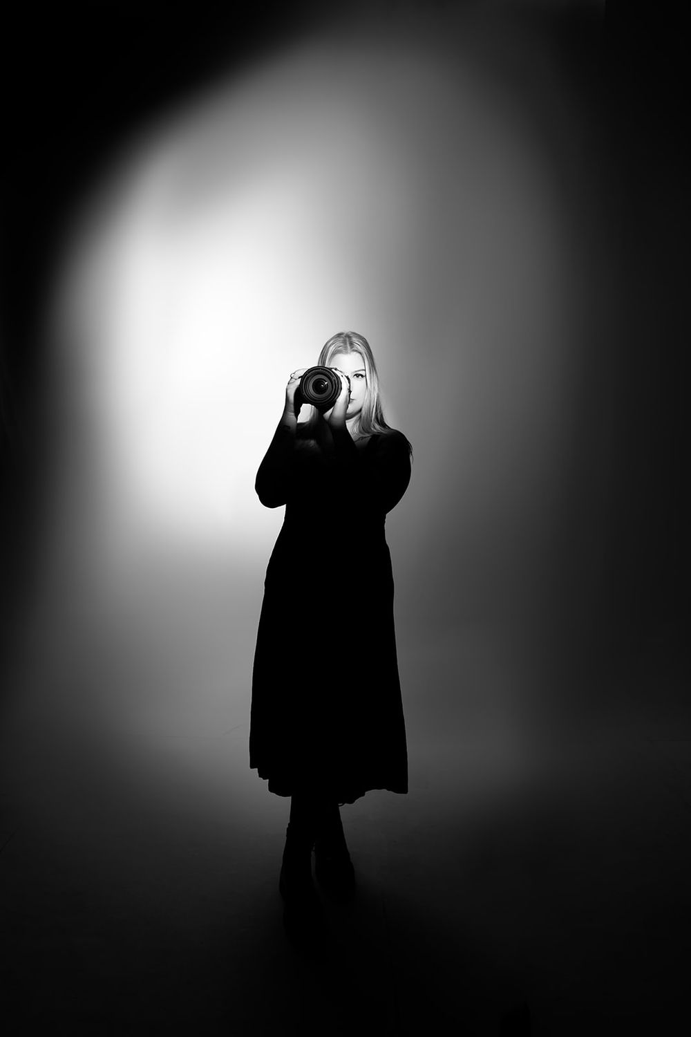Dramatic black and white silhouettes dancing in sequence against a bright white backdrop create an artistic performance series.
