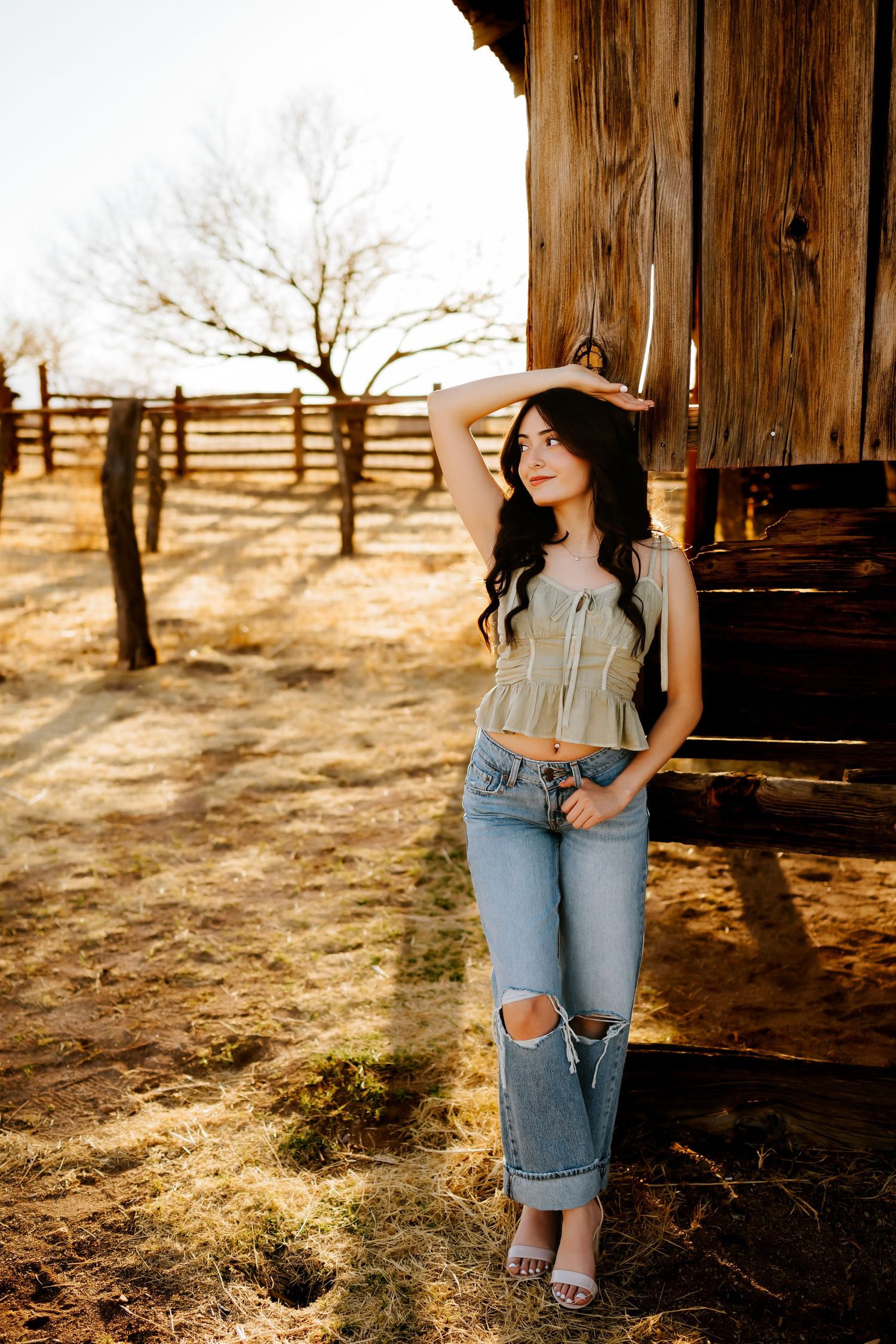 Senior girl sitting at barn in Sonoita Arizona golden hour session_03