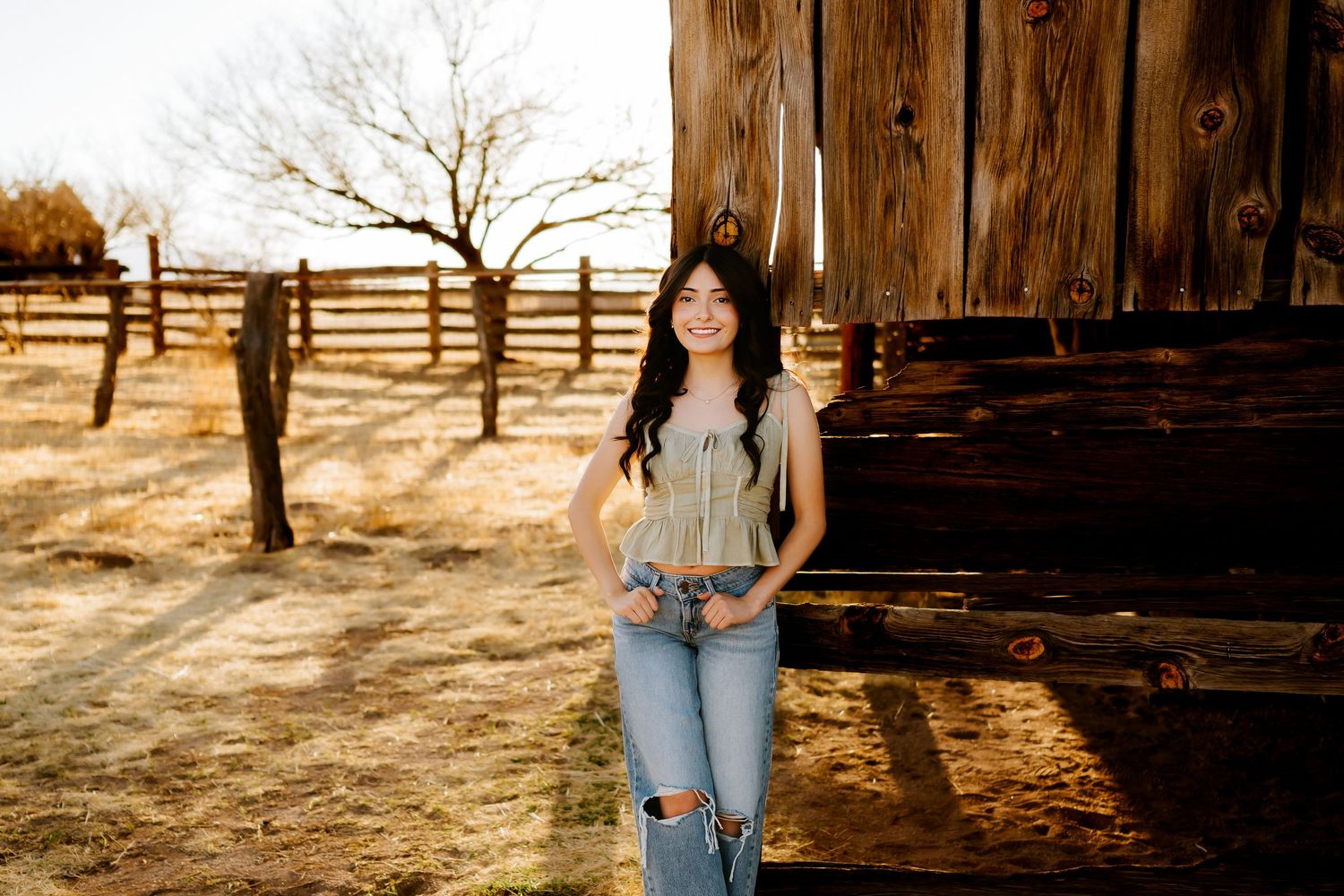 Senior girl sitting at barn in Sierra Vista Arizona golden hour session_04