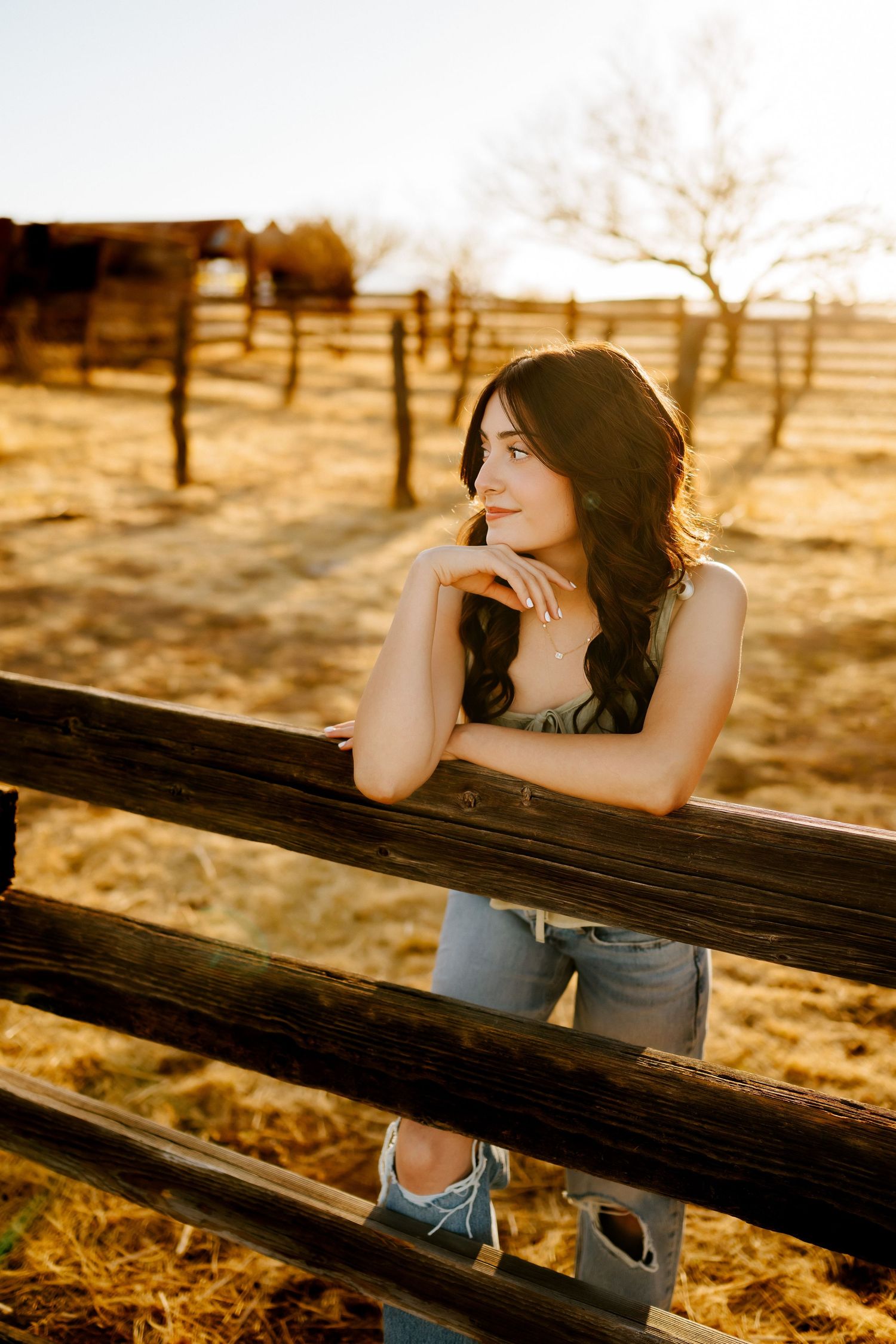 Senior girl sitting at barn in southern Arizona golden hour session_02