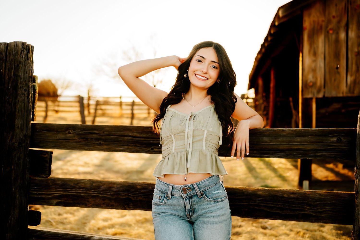 Senior girl sitting at barn in southern Arizona golden hour session_01