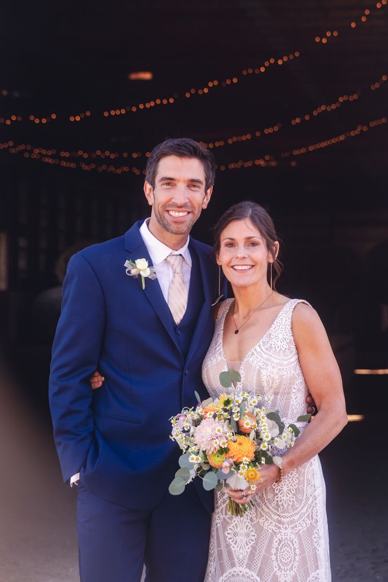A formal portrait of a bride and groom facing the camera with a natural smile.