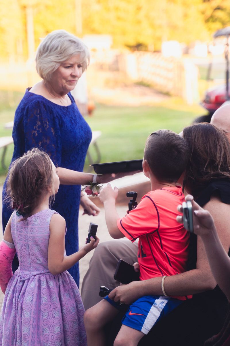 The mother of the bride passes out treats at a DIY wedding reception in South Haven, Michigan.