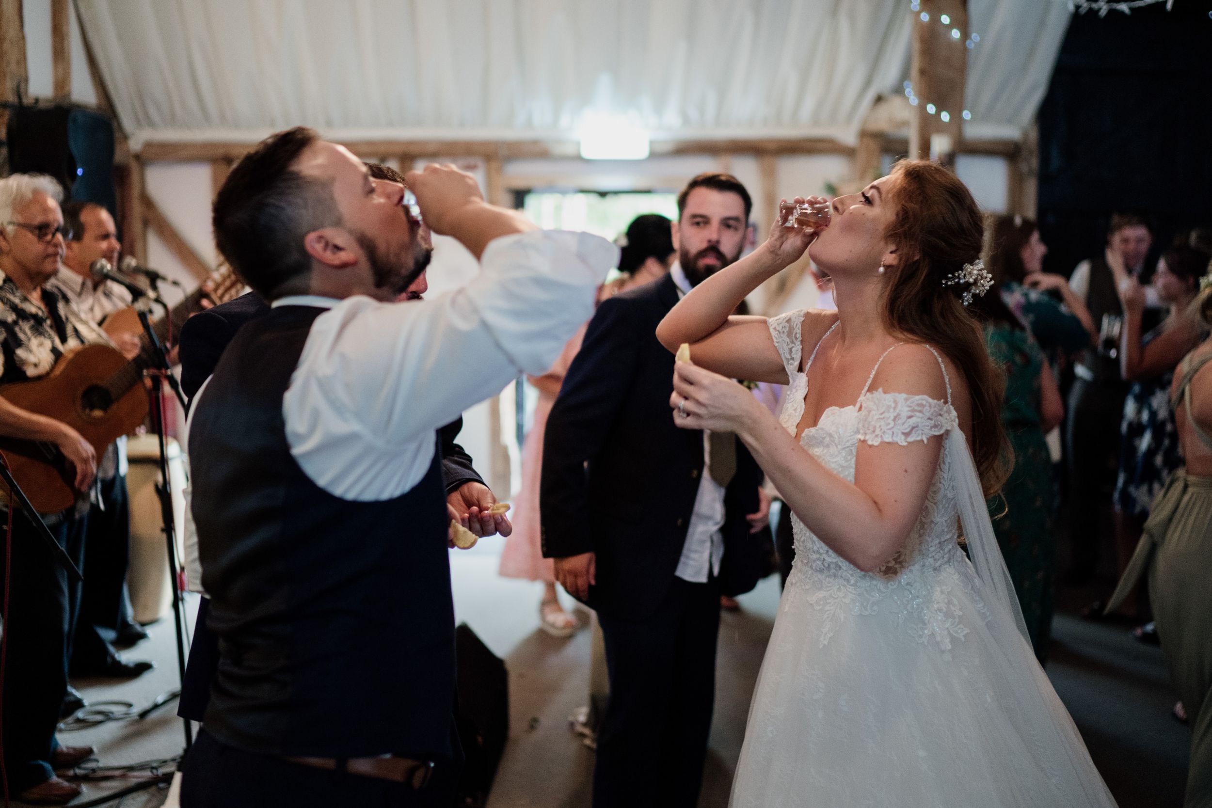Energetic wedding celebration moment with guests dancing and singing at reception.