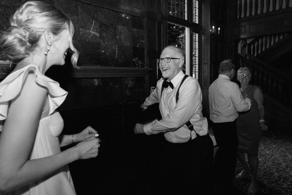 Dance couples enjoying a lively evening gathering in black and white vintage-style photography.