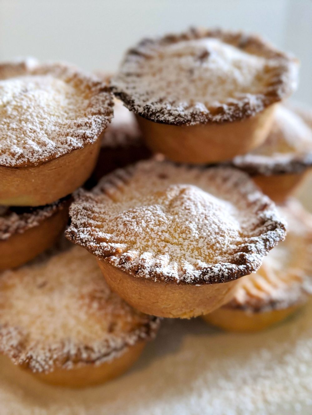 Homemade mince pies dusted with icing sugar arranged in a stack. SIX84 Photography, Event Photography, Sydney