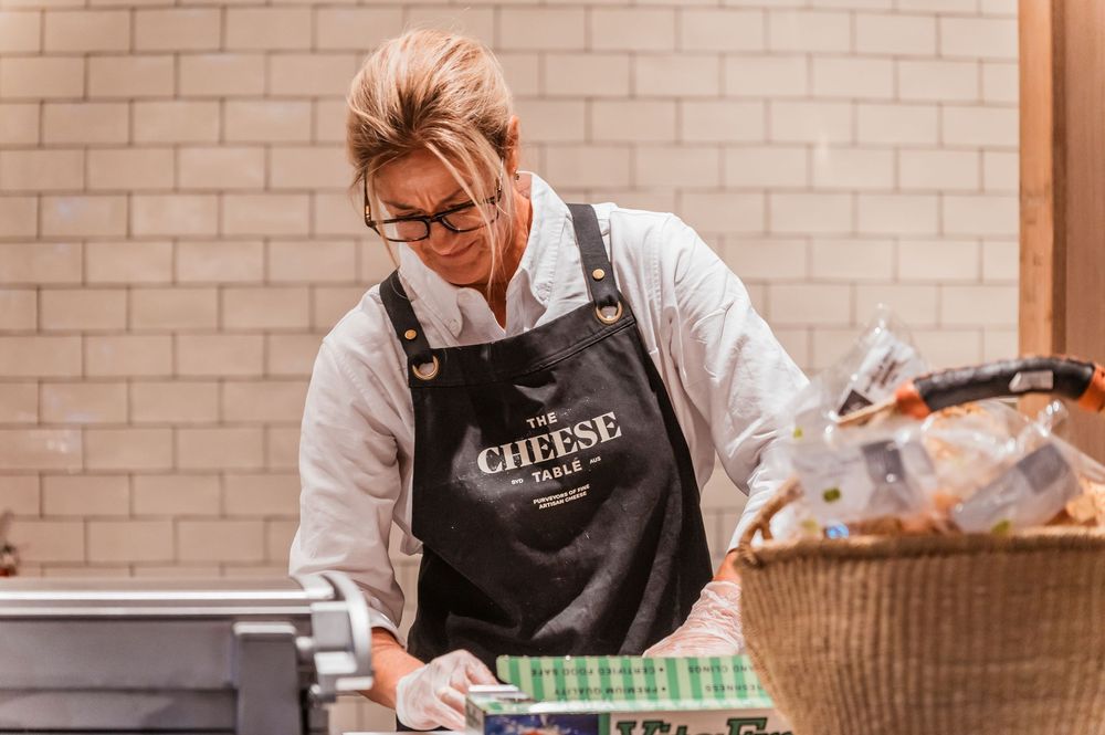 Woman from The Cheese Store working at Hay St market in Sydney. © SIX84 Photography