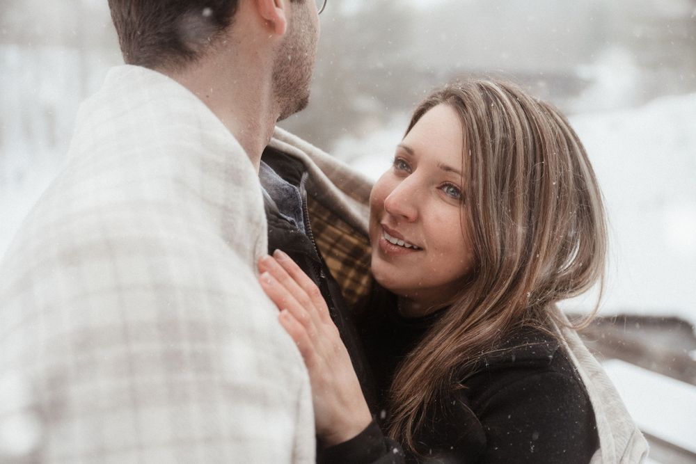 A tender moment between a couple during their winter engagement photo session.