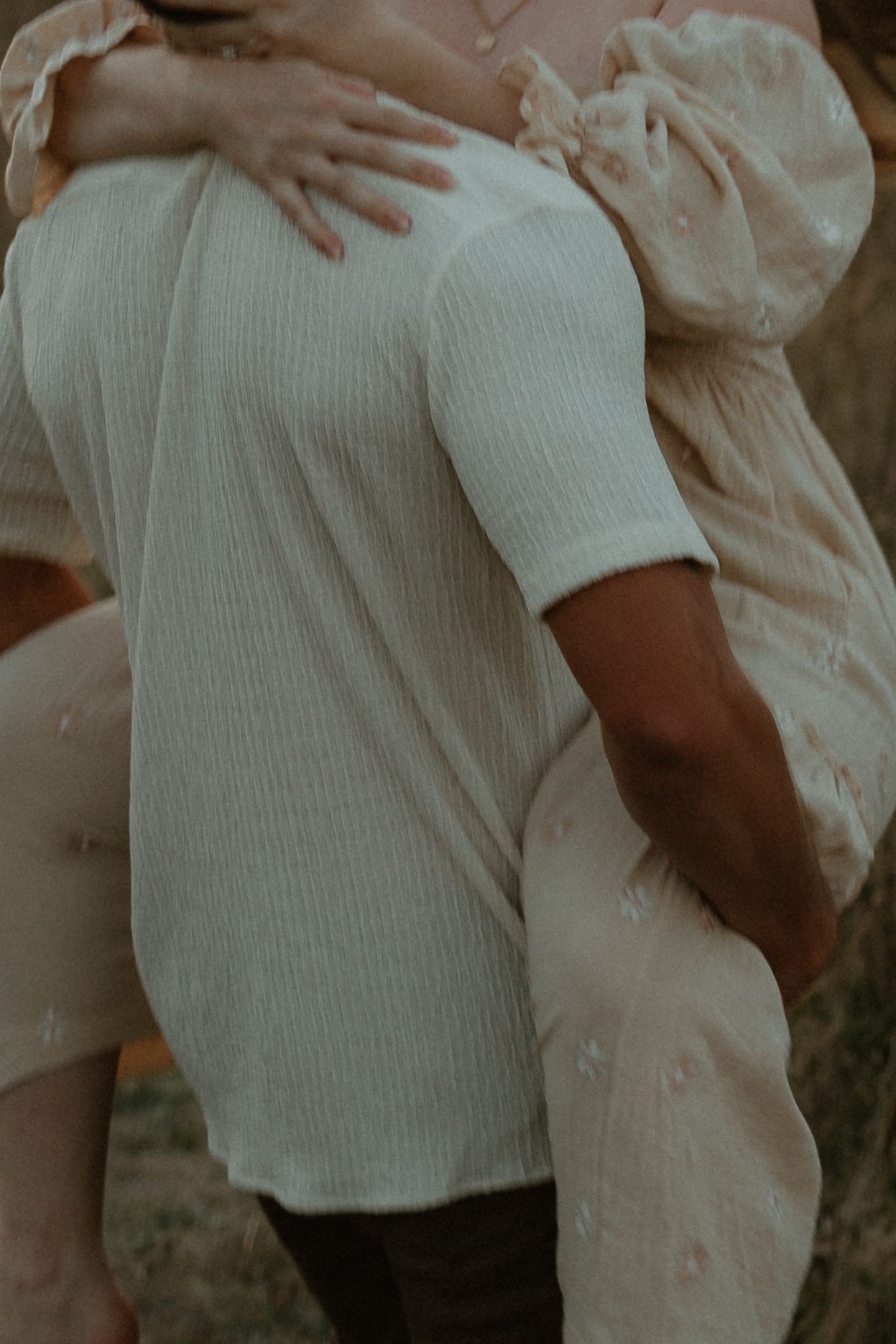 Person in a white ribbed cotton shirt with puffy sleeves stands against a neutral backdrop.