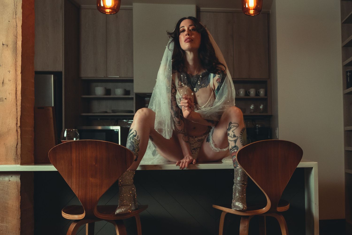 Artistic indoor portrait on wooden counter with ambient lighting.