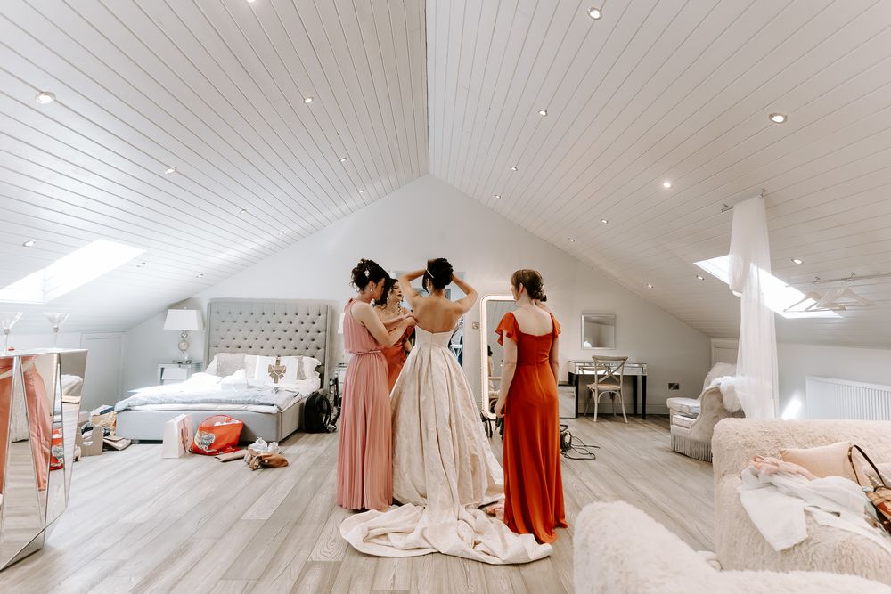 bride getting in her dress